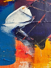 A vivid abstract painting featuring bold, sweeping strokes of color. The canvas includes rich shades of blue, red, yellow, and white, blending together to create dynamic shapes and textures. Thick, textured layers of paint are applied, with visible brushstrokes and a sense of movement and energy.