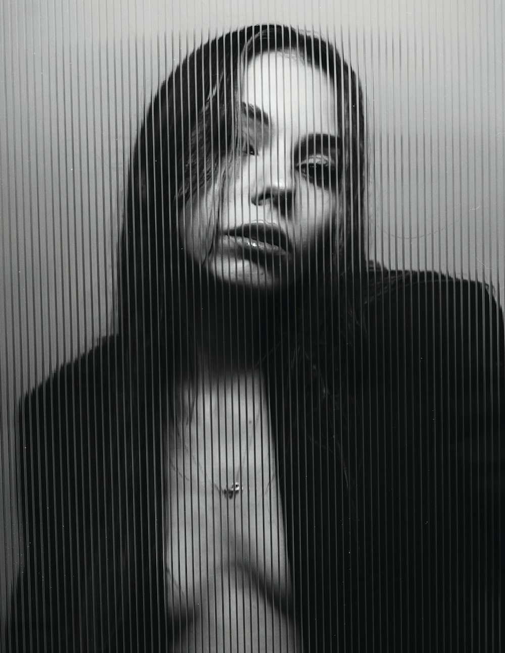 a black and white photo of a woman with long hair