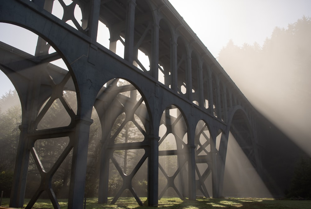 a bridge that is over some grass and trees