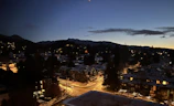 Evening view of Forevermore Community homes glowing softly under street lamps.