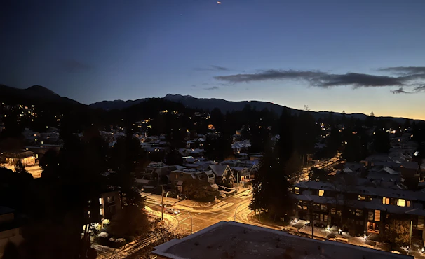 Evening view of the peaceful, low-density neighborhood with soft street lighting and quiet surroundings.