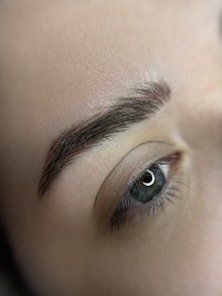 a close up of a person's eye with a pair of scissors