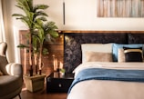 A tranquil bedroom featuring calming colors and plants.