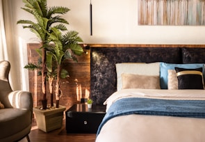 A tranquil bedroom featuring calming colors and plants.