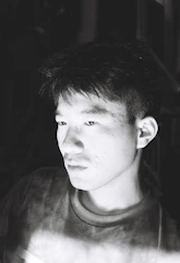 Minimalistic black and white portrait of a thinker lost in reflection.