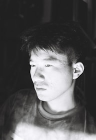 A serene black and white portrait of a person lost in thought.