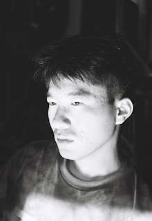 An artistic black and white portrait capturing a thoughtful expression