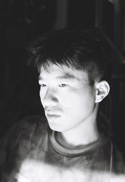 A black and white charcoal sketch of a thoughtful portrait.