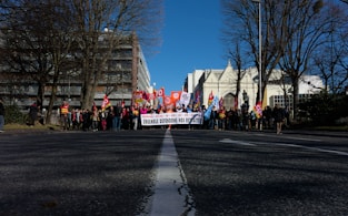 a group of people standing on the side of a road
