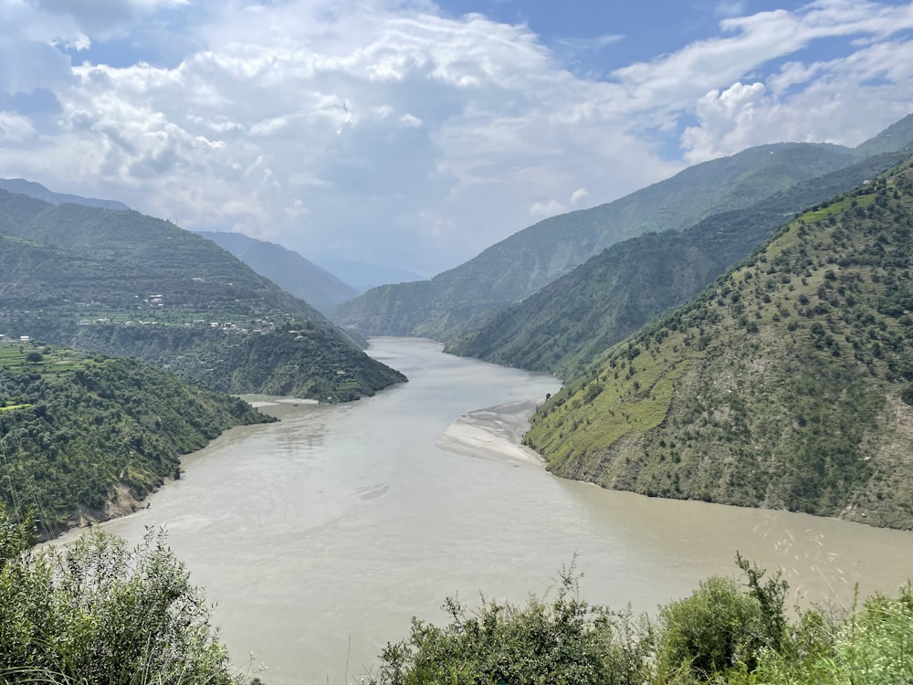 a river flowing through a lush green valley