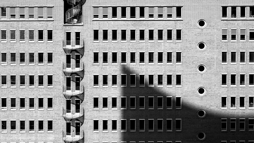 a shadow of a person standing in front of a building