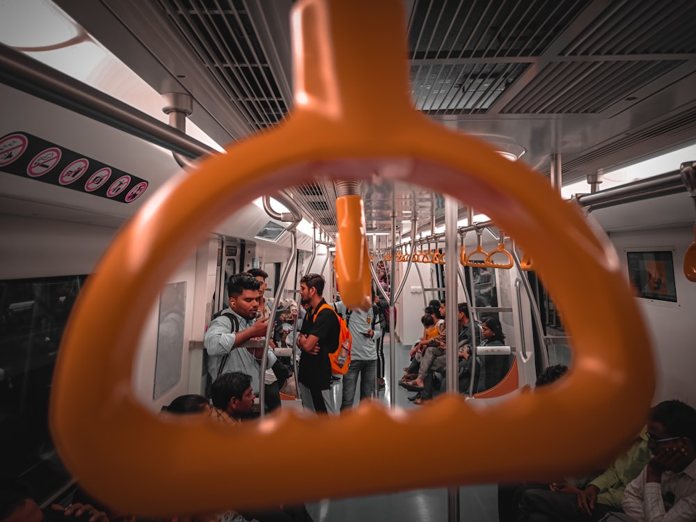 a group of people riding on a subway train