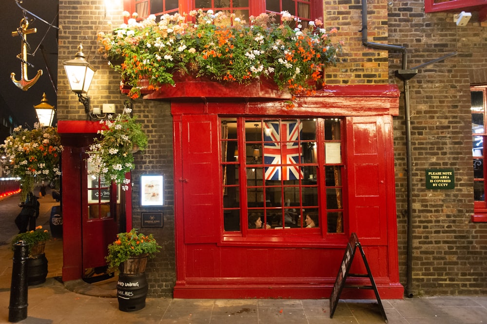 a red phone booth with a british flag on it