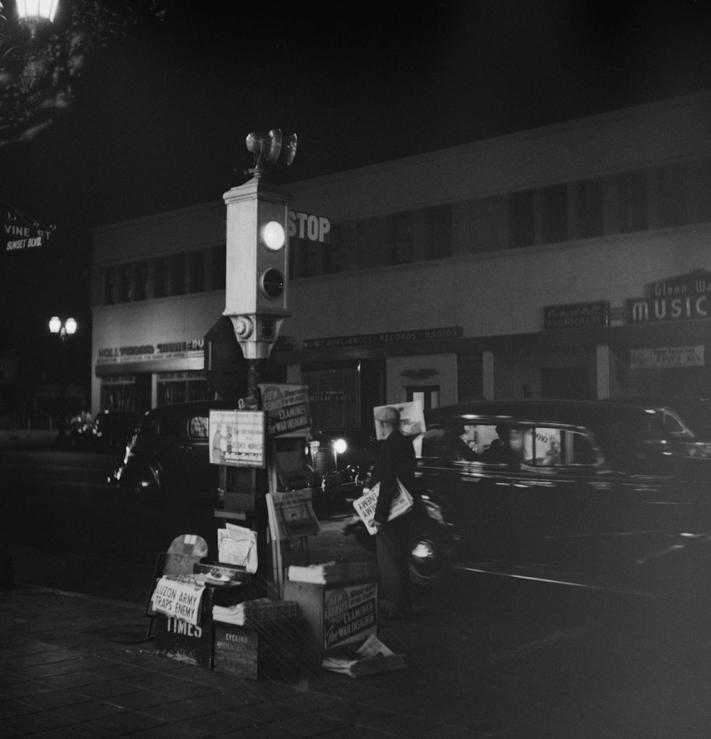 Los Angeles, California. Newsboy's stand and traffic signal light.