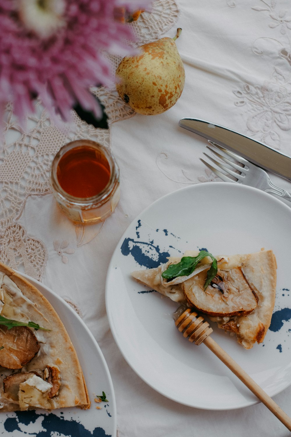 a plate of food on a table next to a glass of tea