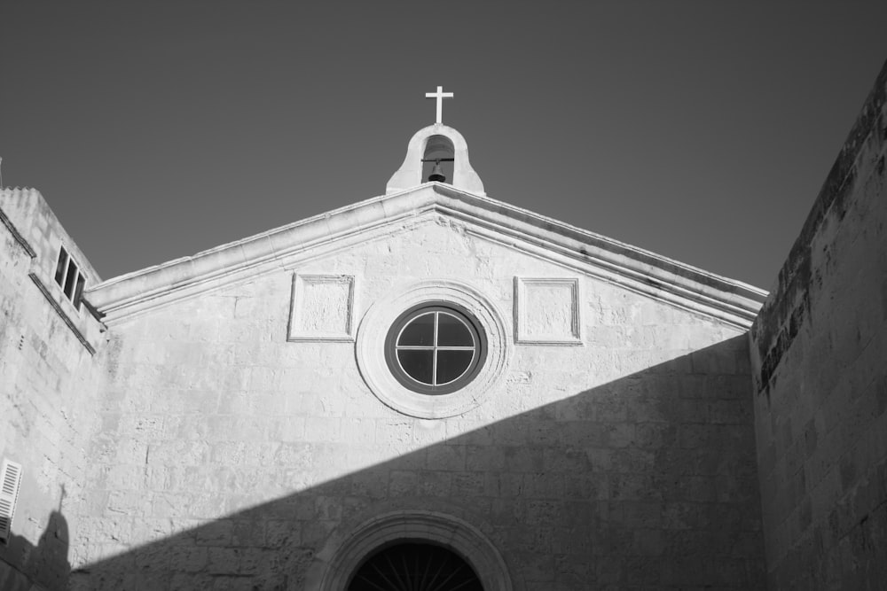 a black and white photo of a church with a cross on top