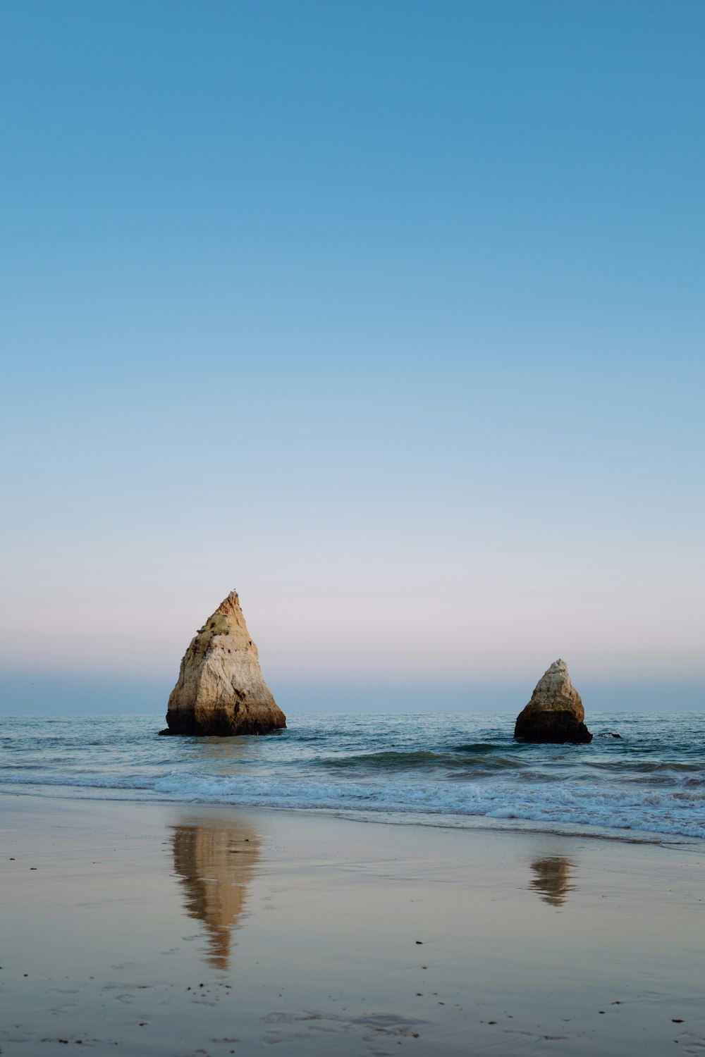 a large rock sticking out of the ocean