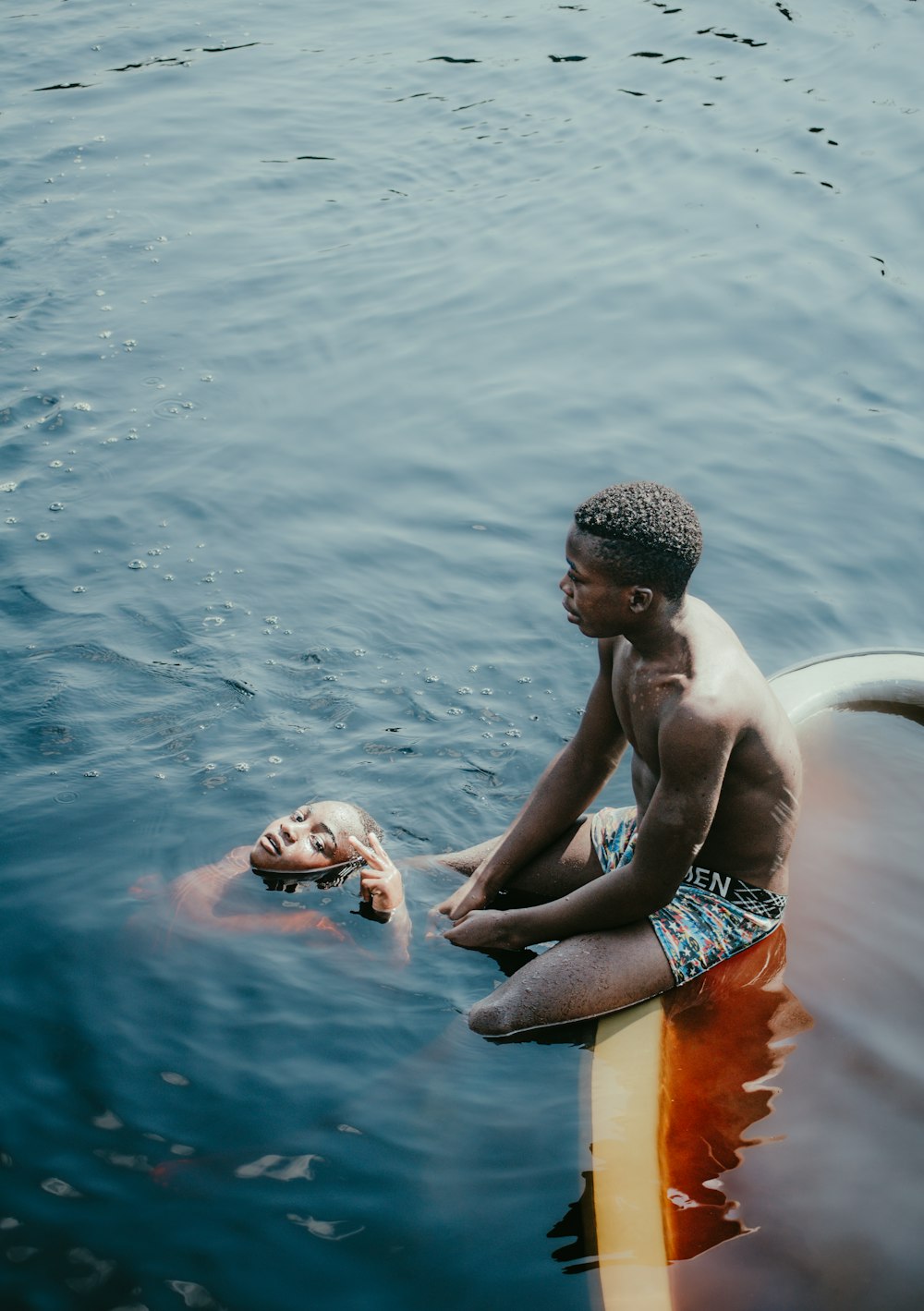 a man sitting on a surfboard in the water