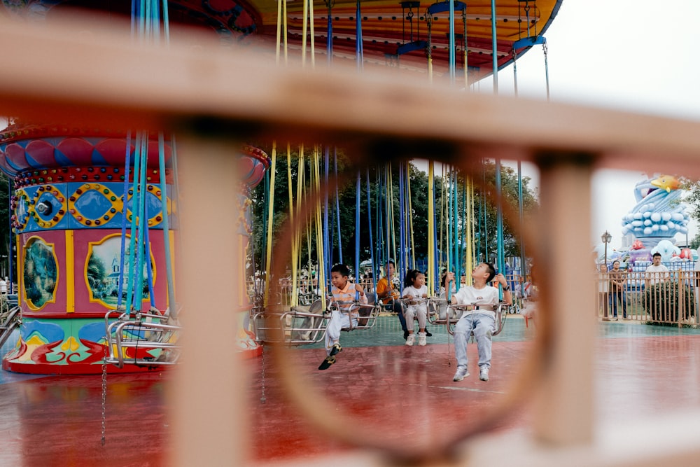 a view of a carousel through a fence