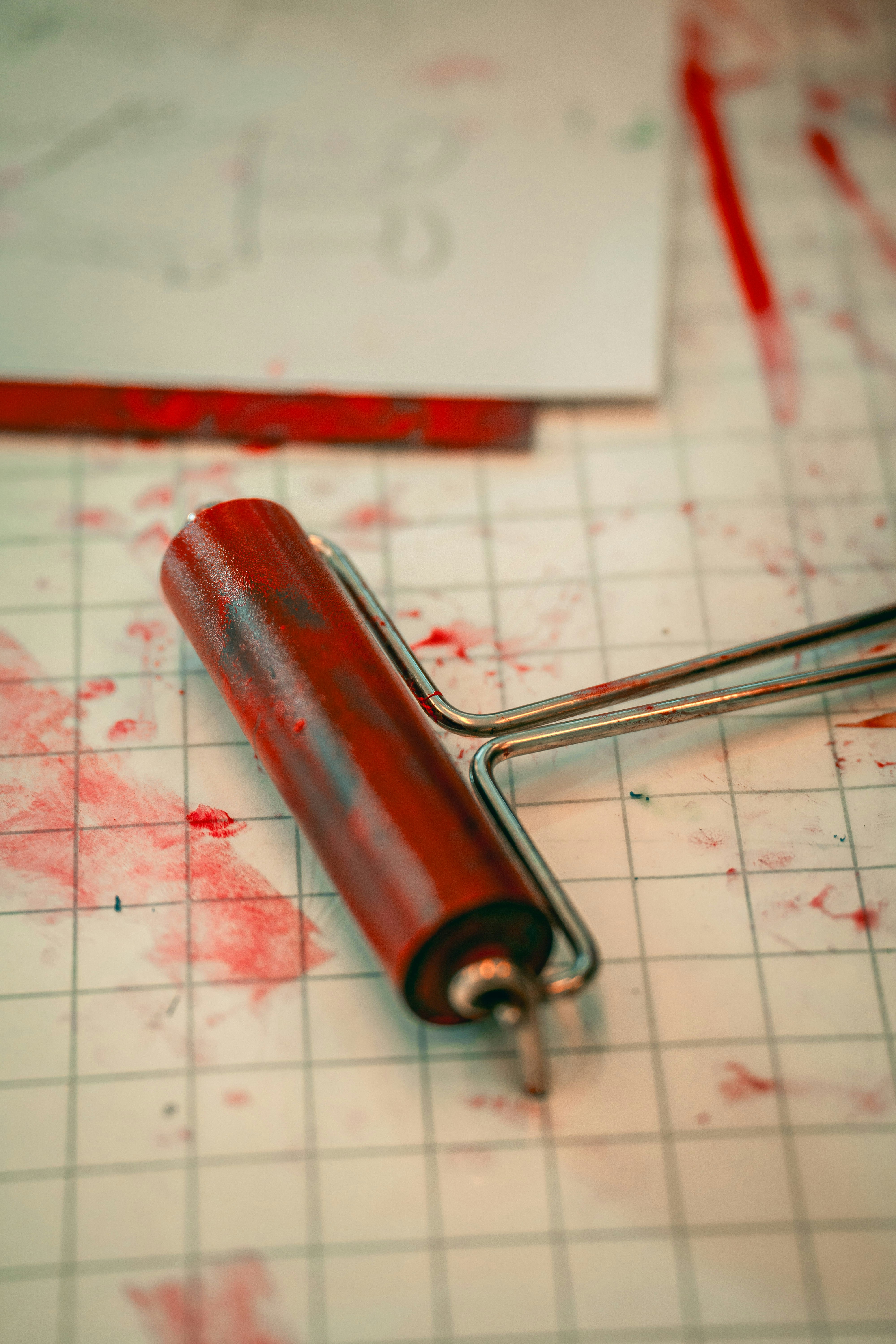 a red pen laying on top of a piece of paper