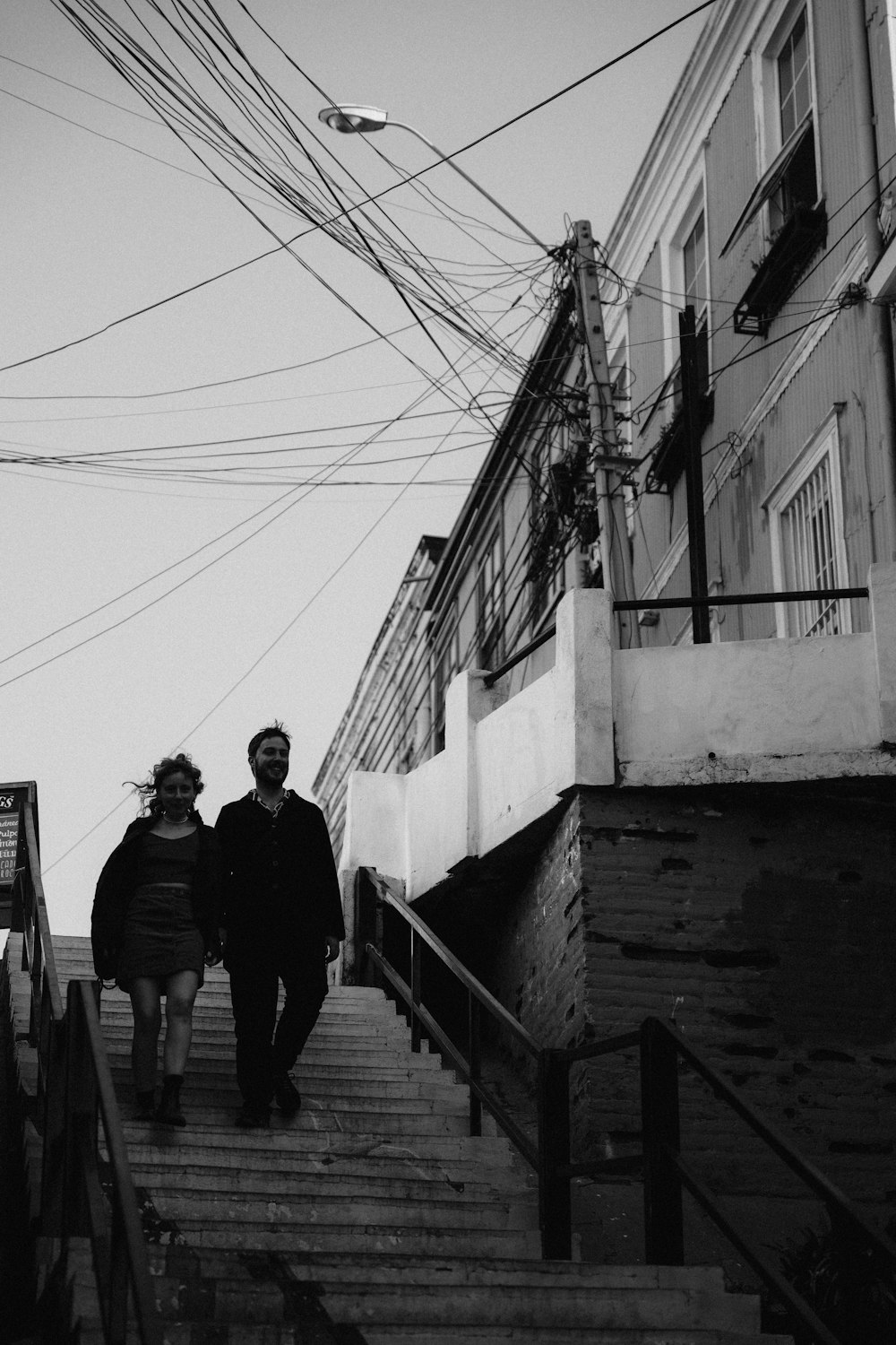 a couple of people walking down a flight of stairs