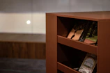 Close-up of a professional cleaner’s hands meticulously dusting a bookshelf.