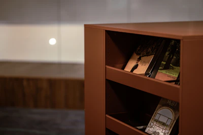 Close-up of a professional cleaner’s hands meticulously dusting a bookshelf.