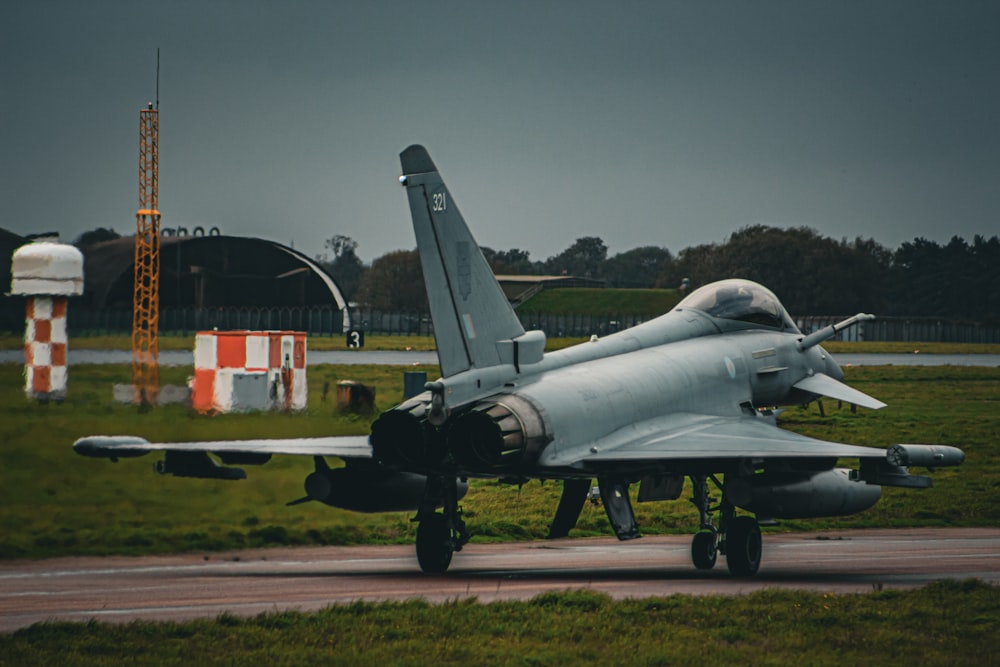 a fighter jet sitting on top of a runway