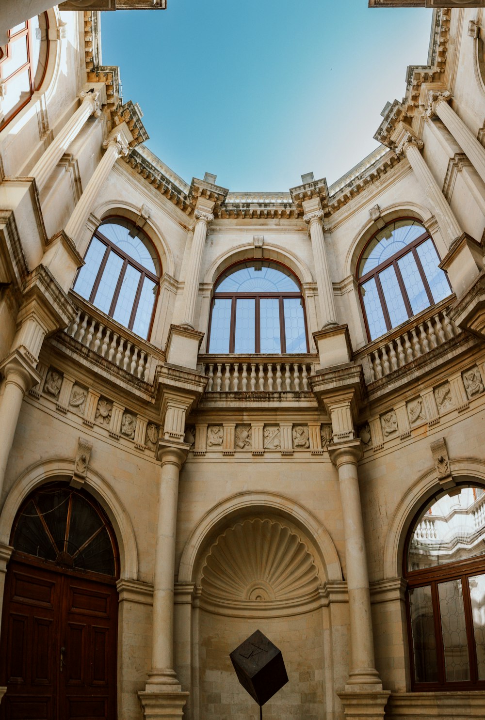 a circular room with two windows and a clock on the wall