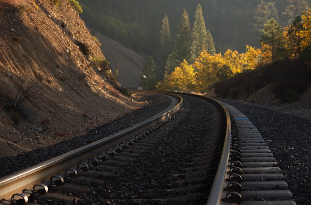 a train track with a mountain in the background