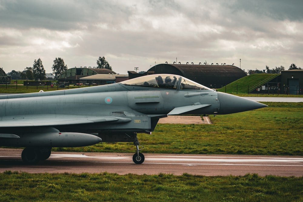 a fighter jet sitting on top of a runway