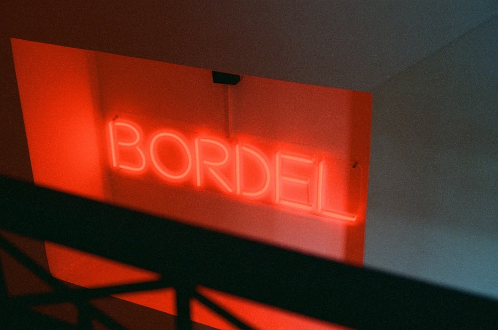 a red neon sign that reads bordil