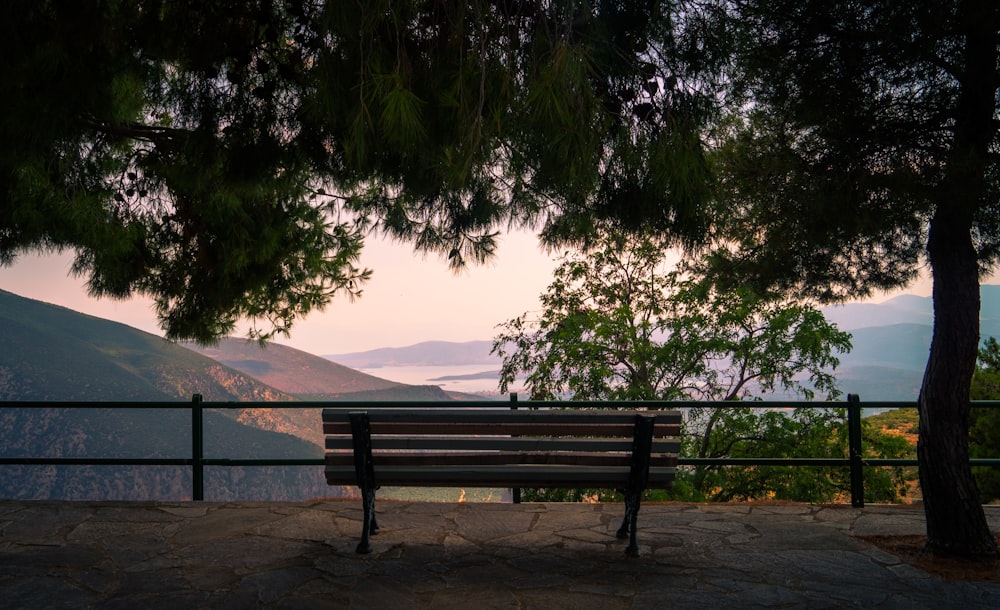 a wooden bench sitting on top of a stone floor