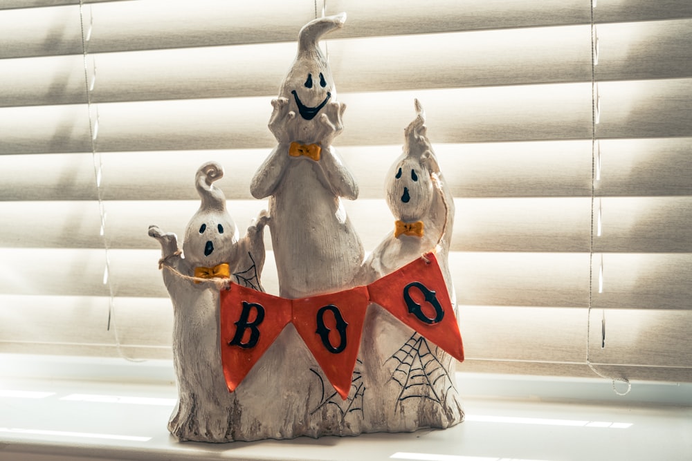a group of halloween decorations sitting on top of a window sill