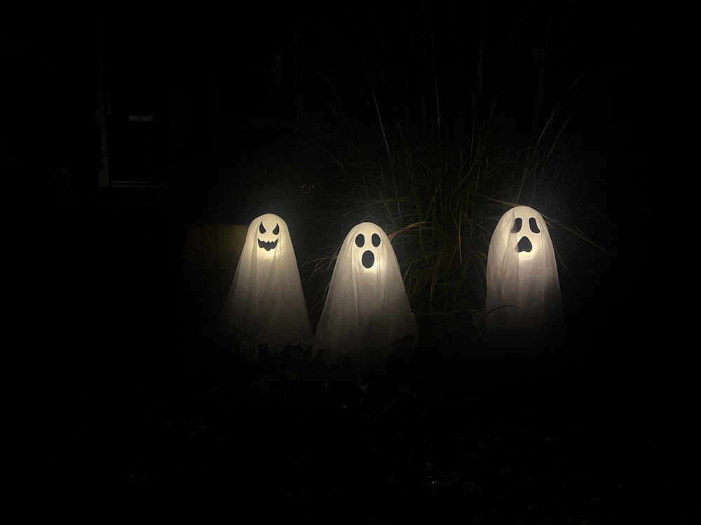 three ghostly ghost figures in the dark