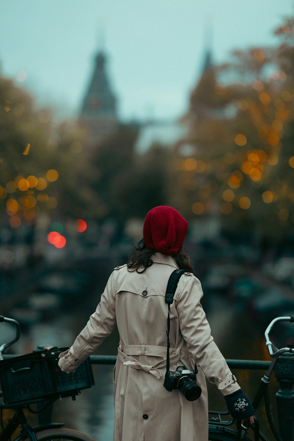 a woman standing next to a bike on a bridge