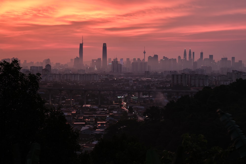 a view of a city at sunset from a hill