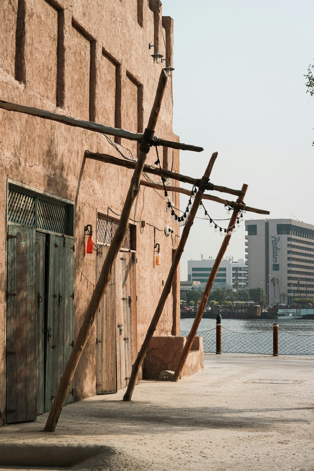 a wooden cross hanging from the side of a building