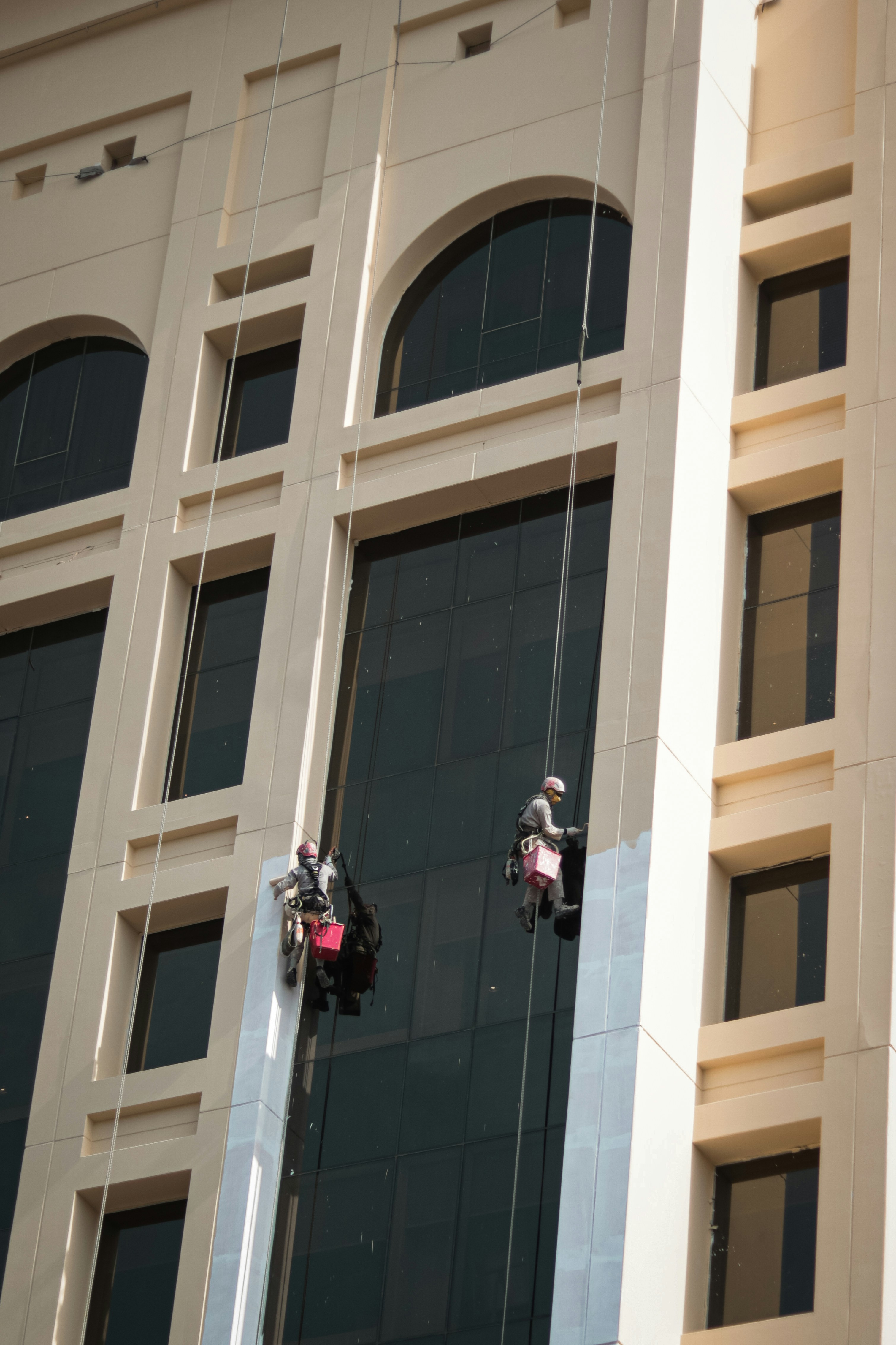 a couple of people on a rope in front of a building