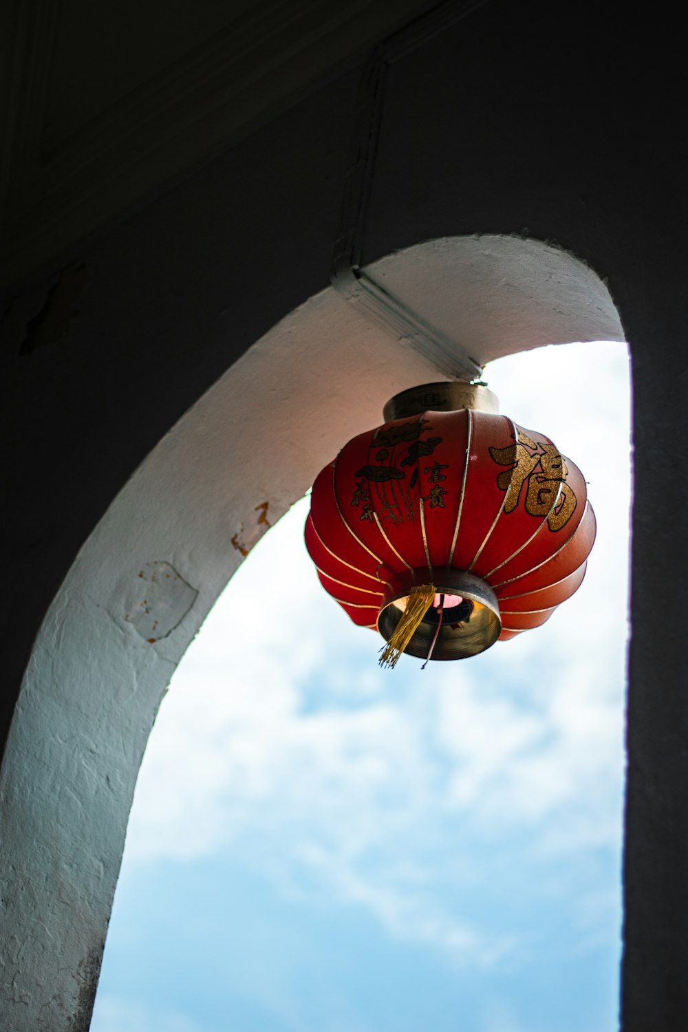 a red lantern hanging from the side of a building