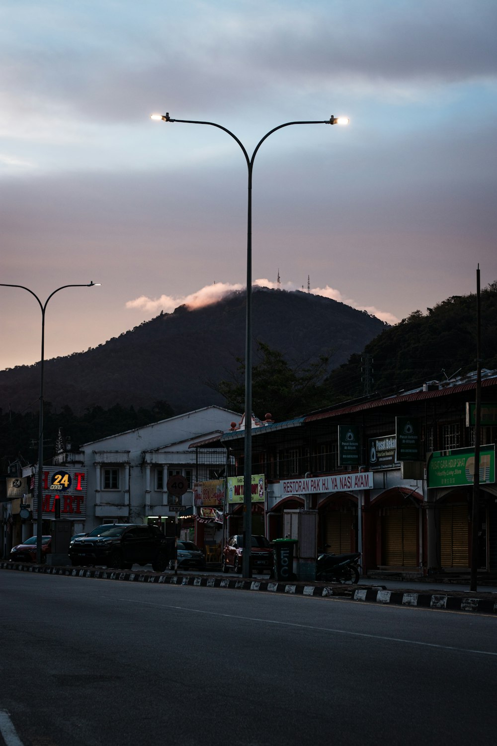 a city street with a mountain in the background