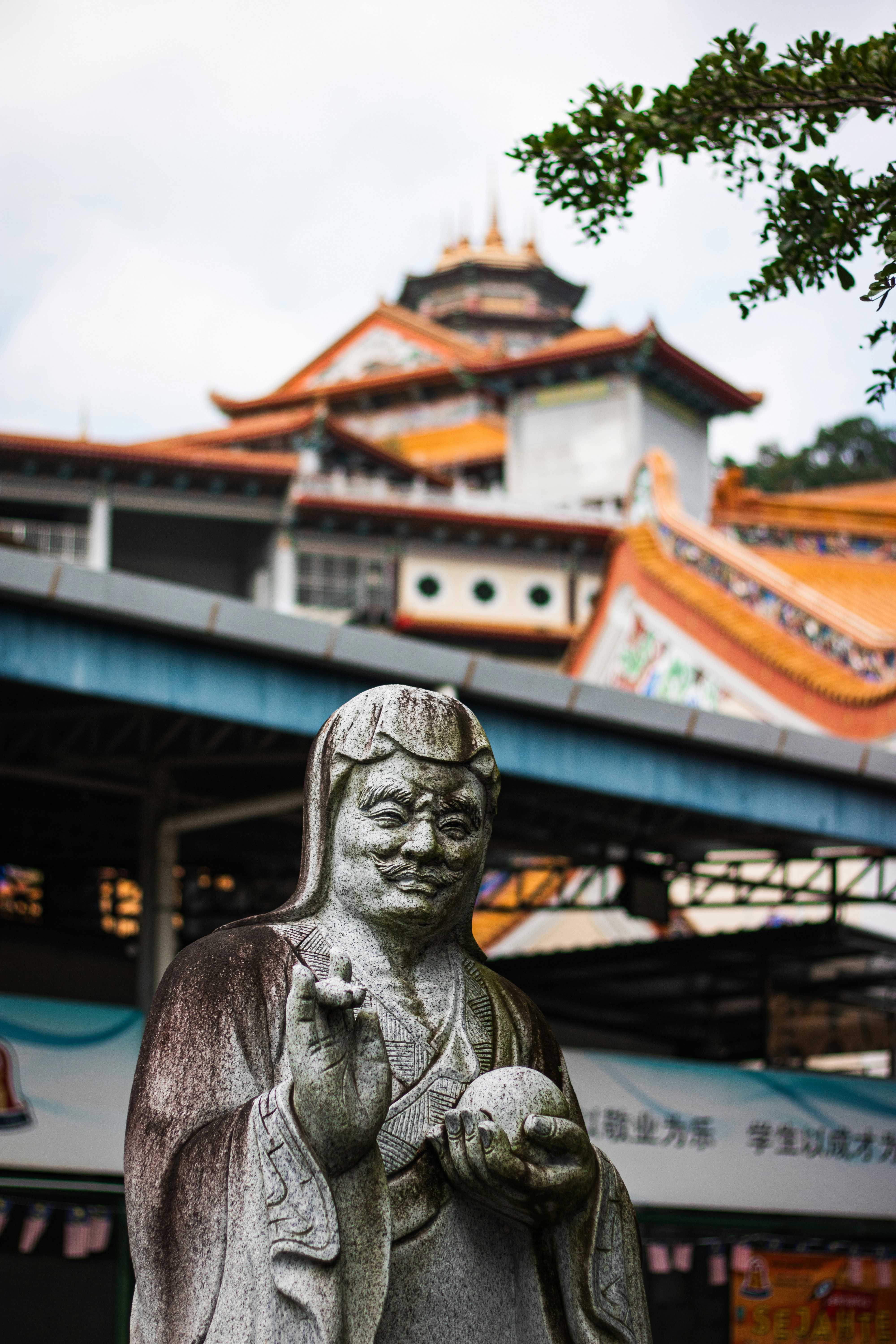 a statue of a person holding a bird in front of a building