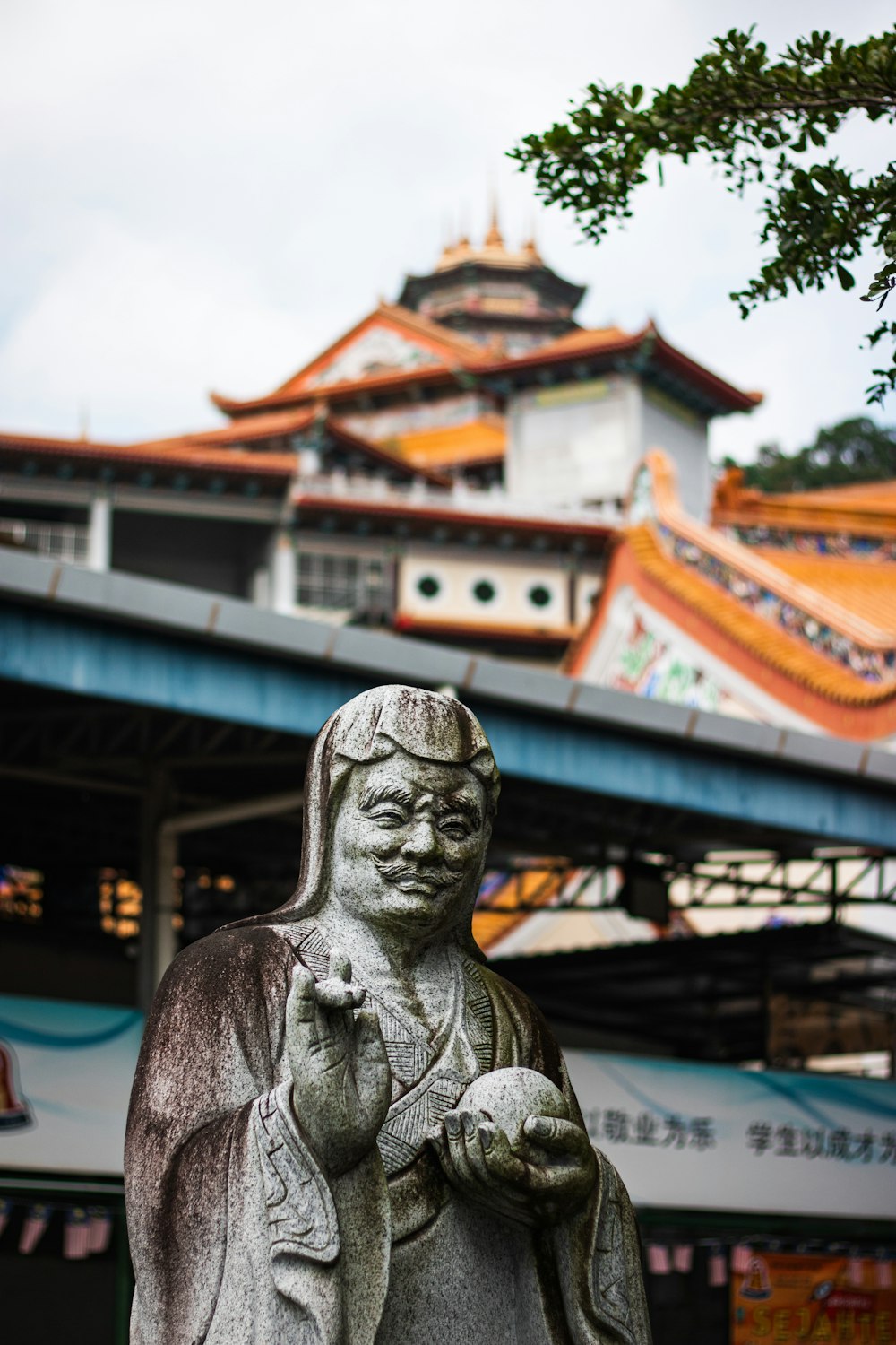 a statue of a person holding a bird in front of a building