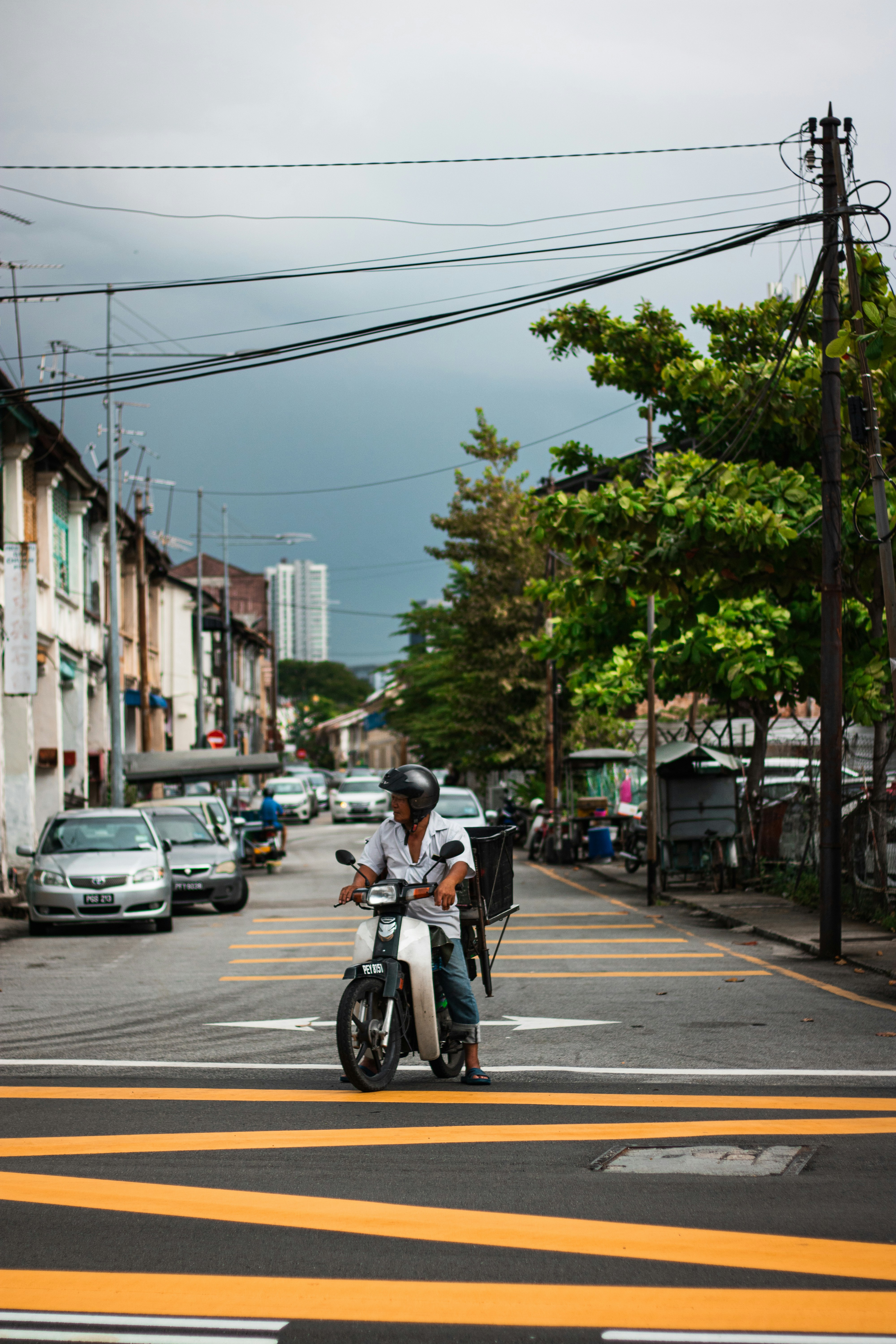 a person riding a scooter on a city street