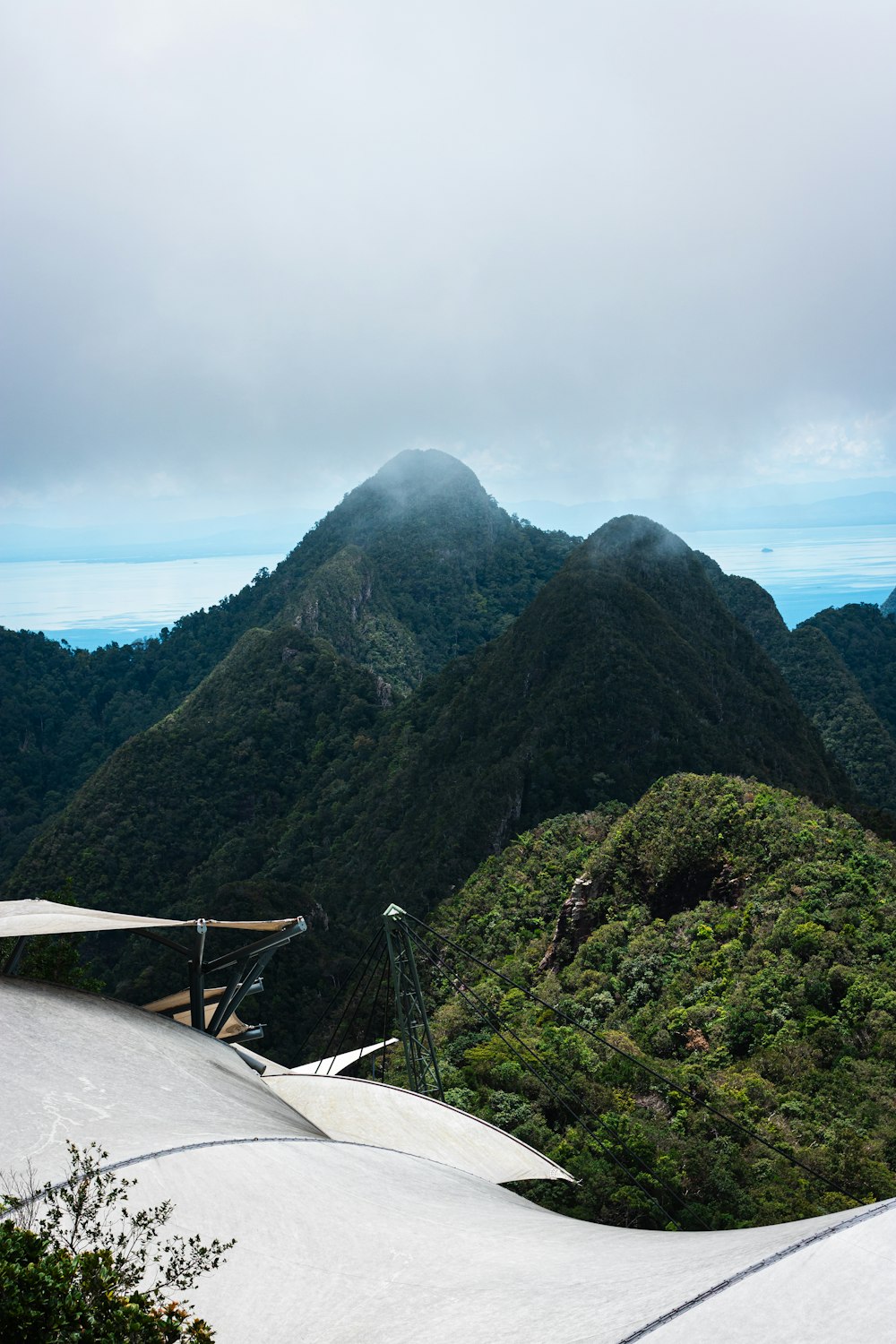 a view of a mountain range from the top of a hill