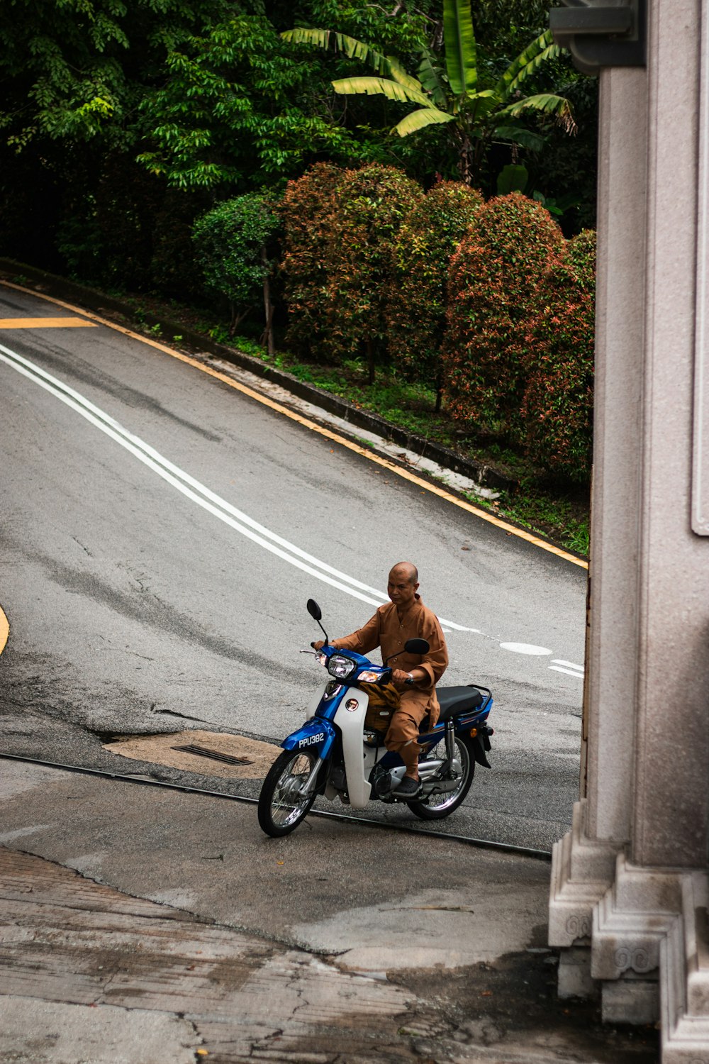 a man riding a motorcycle down a street