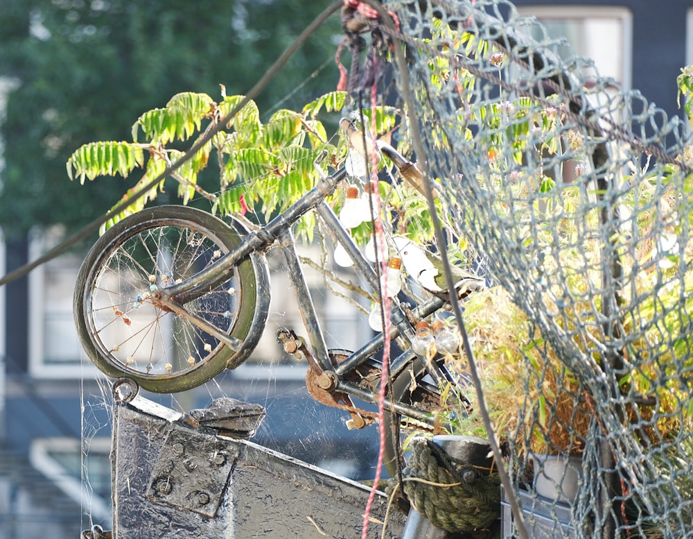 a bicycle is hanging from a wire fence