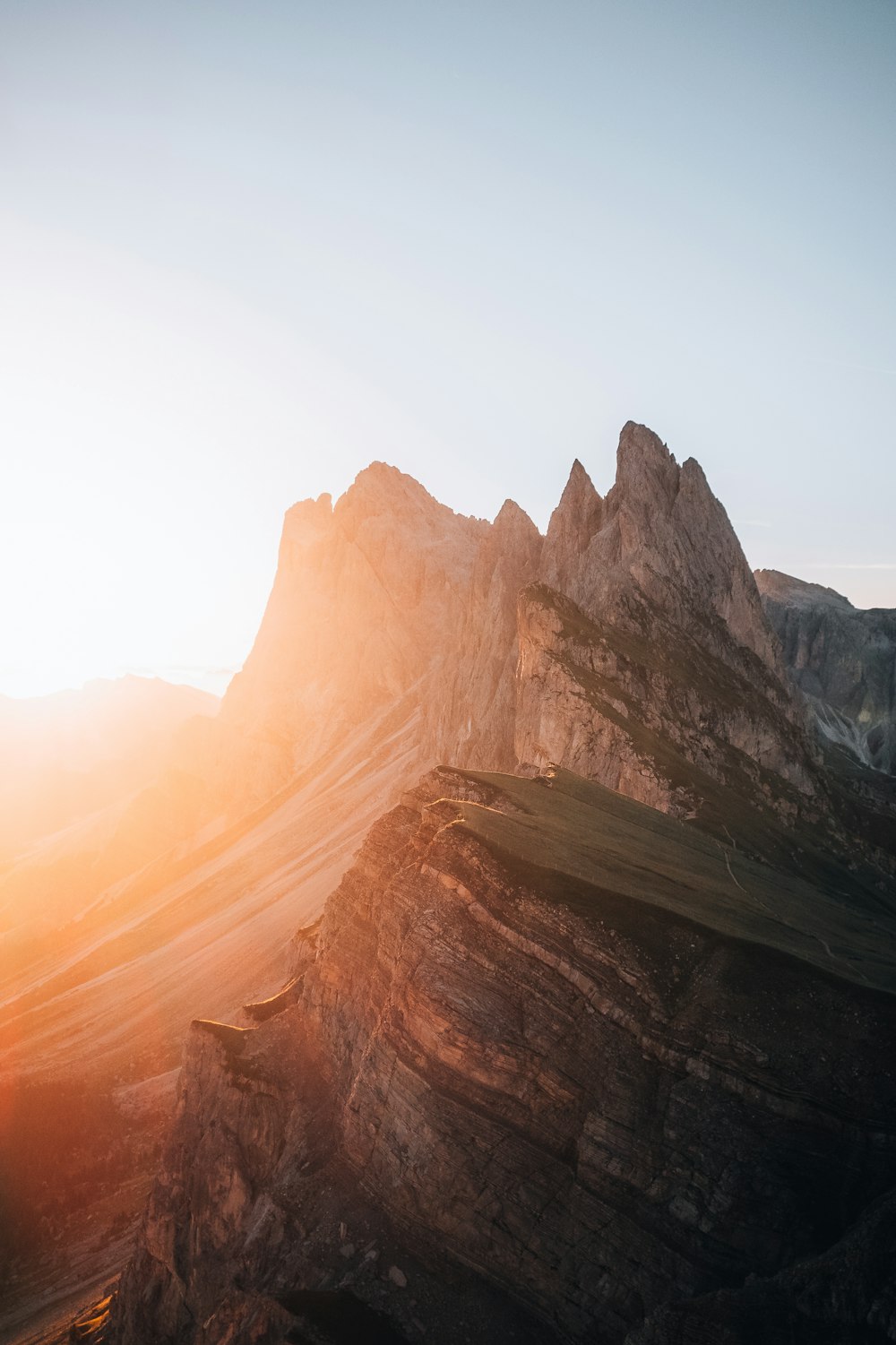 the sun is setting on a mountain range