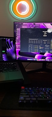 A sleek workspace with dual monitors displaying colorful data visualizations.