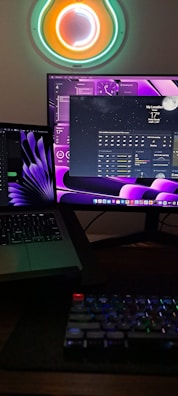 A live stream setup with multiple monitors showing weather updates and time for upcoming meetups.